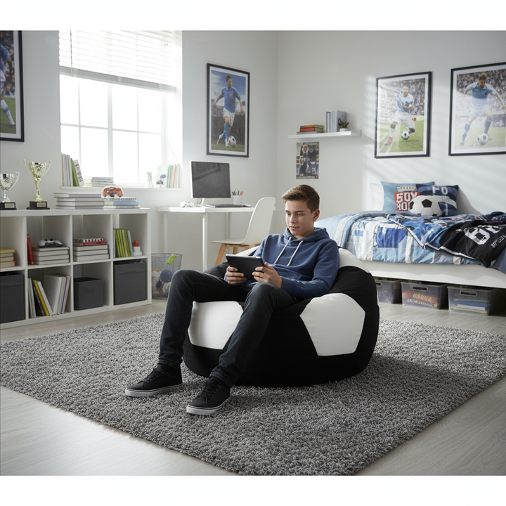 Person sitting on a bean bag chair in a modern living room, using a tablet.